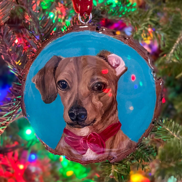 Christmas ornament with a dog's portrait wearing a festive bow-tie.