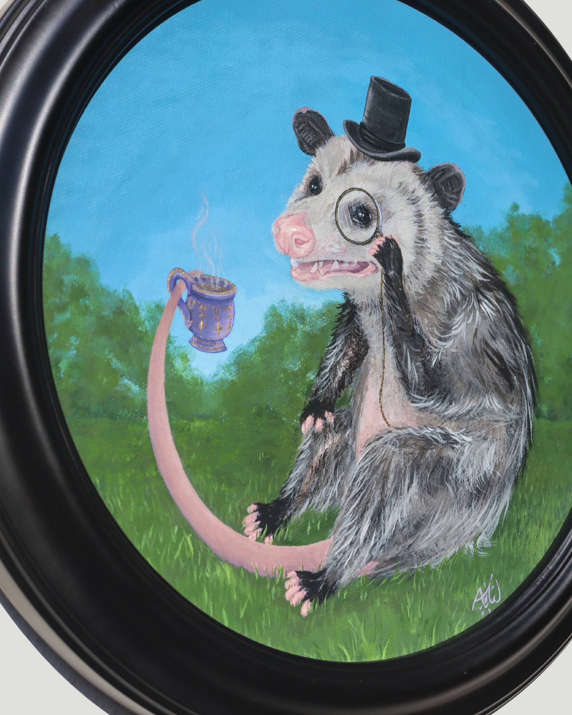 A framed circular painting depicting an opossum wearing a small black top hat and magnifying glass, sitting on green grass and holding a purple mug with a long pink tail extending toward it, set against a blue sky.